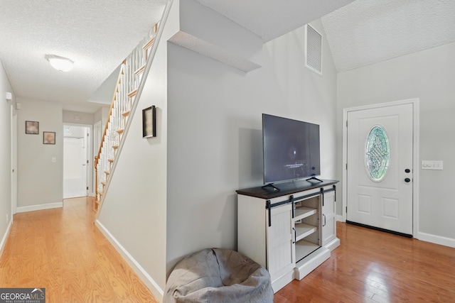 194 Retreat Pl, Woodbine, GA 31569 - entryway featuring a textured ceiling, light wood-style floors, and stairs