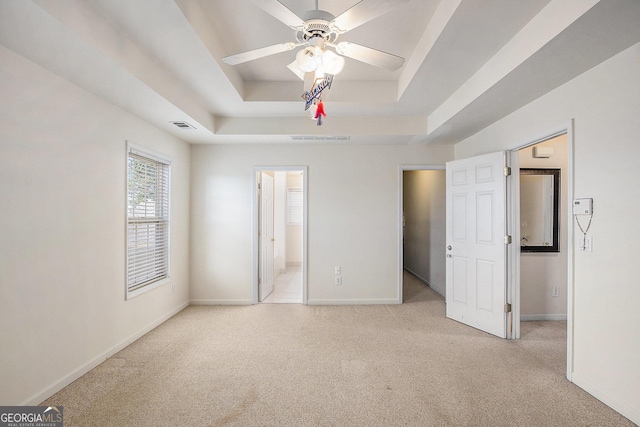 2770 Nautical Way, Villa Rica, GA 30180 - unfurnished bedroom featuring a tray ceiling, light colored carpet, and ensuite bath