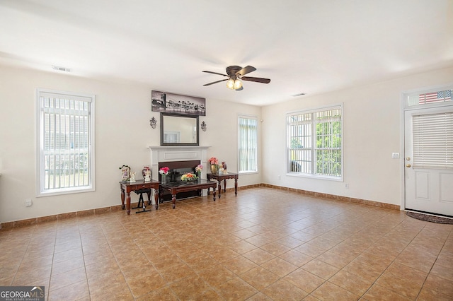 2770 Nautical Way, Villa Rica, GA 30180 - foyer entrance with ceiling fan, a fireplace, and light tile patterned flooring