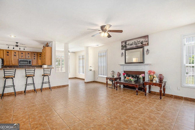 2770 Nautical Way, Villa Rica, GA 30180 - living room with plenty of natural light, light tile patterned floors, a ceiling fan, and a fireplace