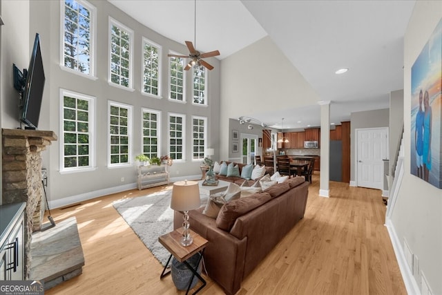 7049 Bennington Ln, Cumming, GA 30041 - living room featuring a towering ceiling, light wood-style floors, ceiling fan, healthy amount of natural light, and recessed lighting