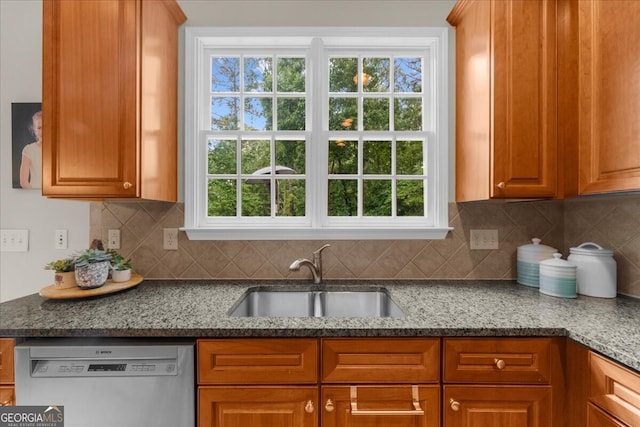 7049 Bennington Ln, Cumming, GA 30041 - kitchen with dishwashing machine, backsplash, dark stone counters, and brown cabinetry