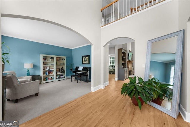 7049 Bennington Ln, Cumming, GA 30041 - foyer with arched walkways, wood finished floors, a towering ceiling, and crown molding
