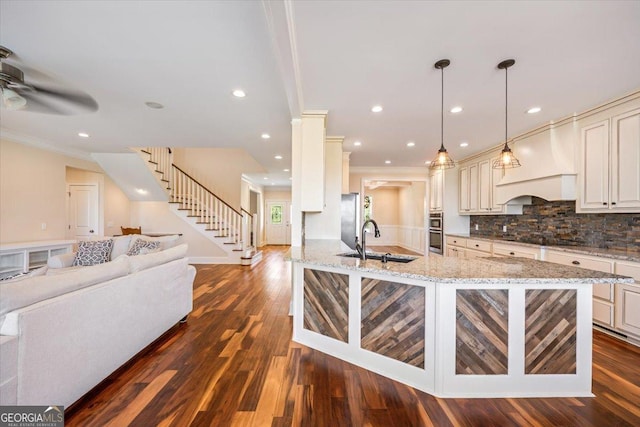 236 Woodland Trail Rd, Cochran, GA 31014 - kitchen with crown molding, premium range hood, open floor plan, light stone counters, and tasteful backsplash