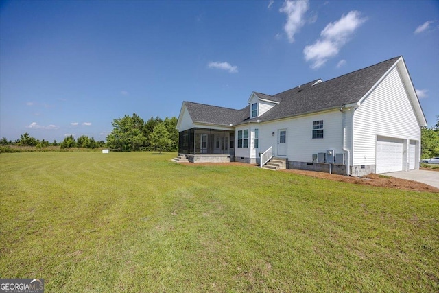 236 Woodland Trail Rd, Cochran, GA 31014 - back of property featuring crawl space, a garage, a sunroom, and a lawn