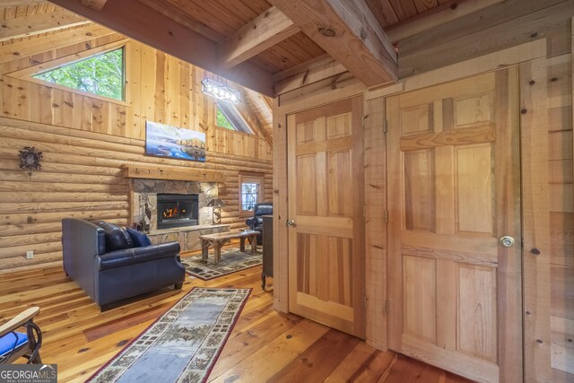 451 Pinecrest Rd, Sautee Nacoochee, GA 30571 - living room featuring rustic walls, wooden ceiling, beamed ceiling, plenty of natural light, and a fireplace