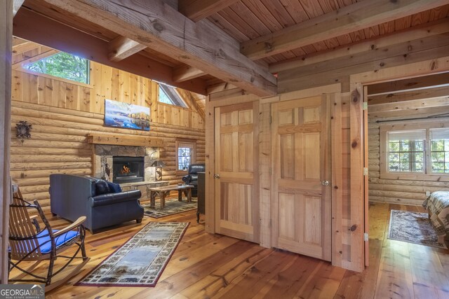 451 Pinecrest Rd, Sautee Nacoochee, GA 30571 - living area with beam ceiling, light wood-style flooring, rustic walls, wood ceiling, and a fireplace