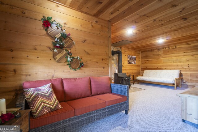 451 Pinecrest Rd, Sautee Nacoochee, GA 30571 - carpeted living area featuring wooden walls, wood ceiling, and a wood stove