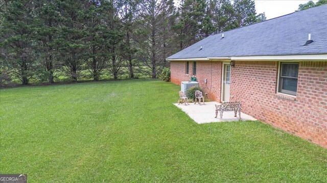 3041 Monroe Hwy, Bogart, GA 30622 - view of green lawn with a patio and central AC