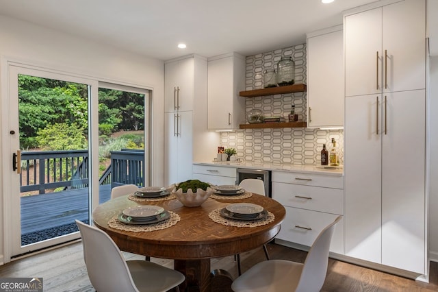 dining space with light wood-type flooring and recessed lighting
