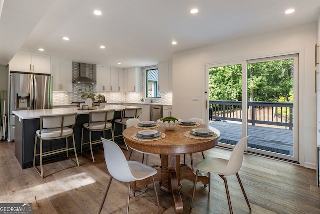 dining room featuring wood finished floors and recessed lighting