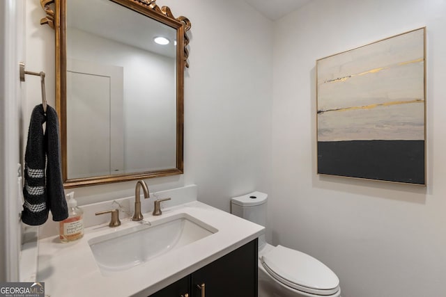 bathroom with toilet and vanity
