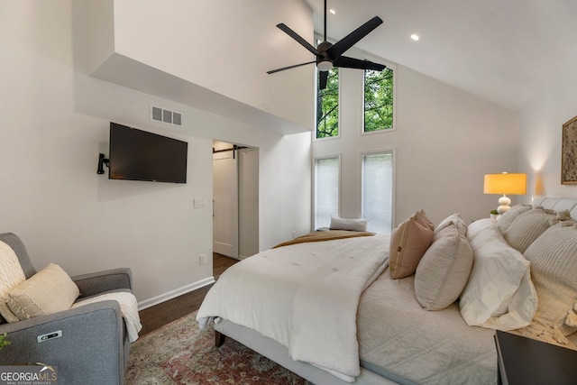 bedroom featuring wood finished floors, high vaulted ceiling, baseboards, ceiling fan, and recessed lighting