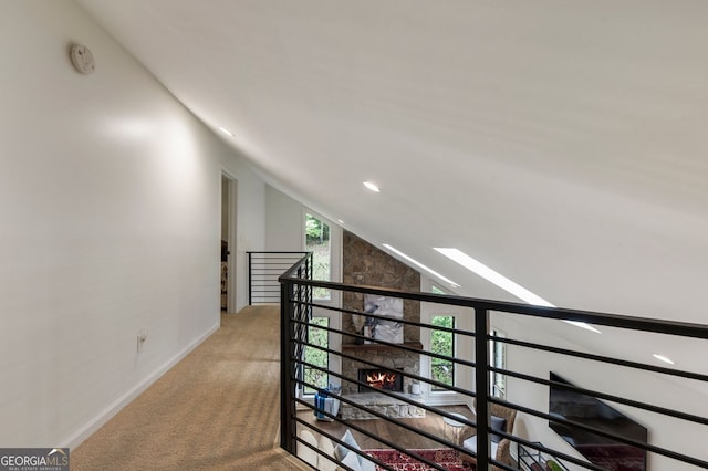hallway with carpet flooring, recessed lighting, baseboards, and vaulted ceiling
