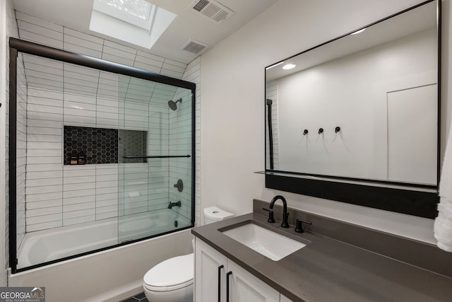 bathroom featuring toilet, bath / shower combo with glass door, vanity, and recessed lighting