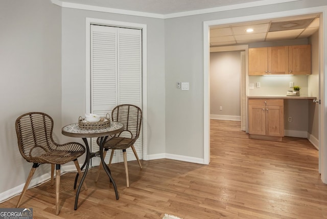 dining space featuring baseboards, light wood finished floors, a drop ceiling, and recessed lighting