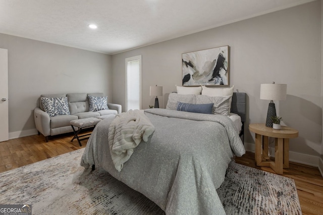 bedroom featuring baseboards and wood finished floors