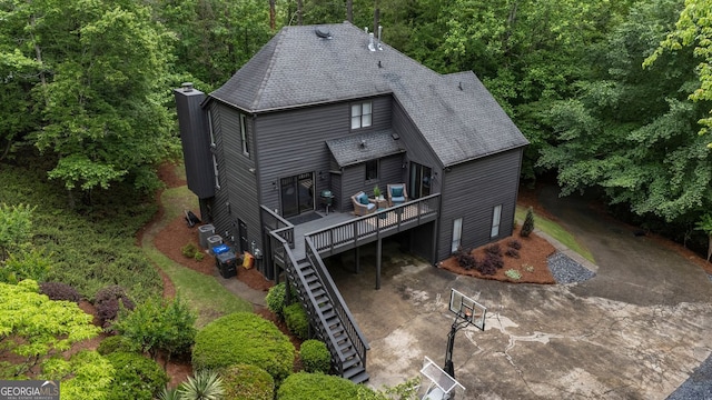 aerial view of property and surrounding area featuring a heavily wooded area