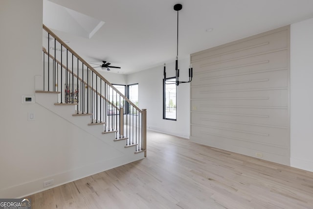 1954 8th St, Chamblee, GA 30341 - stairway featuring wood finished floors, a chandelier, baseboards, and ceiling fan