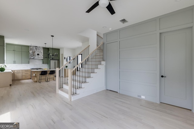 1954 8th St, Chamblee, GA 30341 - stairs with ceiling fan, wood finished floors, and a decorative wall