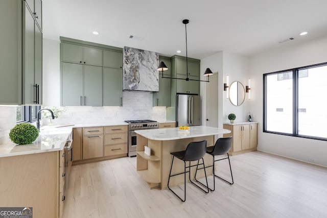 1954 8th St, Chamblee, GA 30341 - kitchen featuring appliances with stainless steel finishes, green cabinets, premium range hood, light wood-style flooring, and plenty of natural light