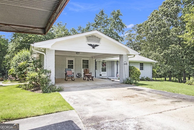 105 Tranquility Dr, Villa Rica, GA 30180 - view of front of property featuring covered porch, brick siding, concrete driveway, and a front lawn