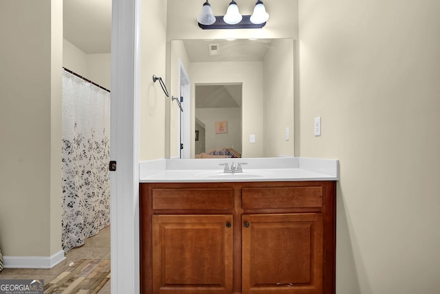 4581 Sagebrush Ct, Snellville, GA 30039 - bathroom with vanity, curtained shower, and wood finished floors