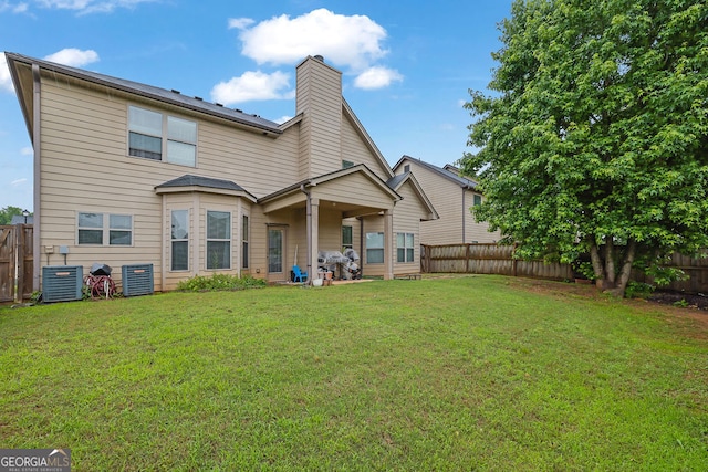 4581 Sagebrush Ct, Snellville, GA 30039 - back of property with central AC and a chimney