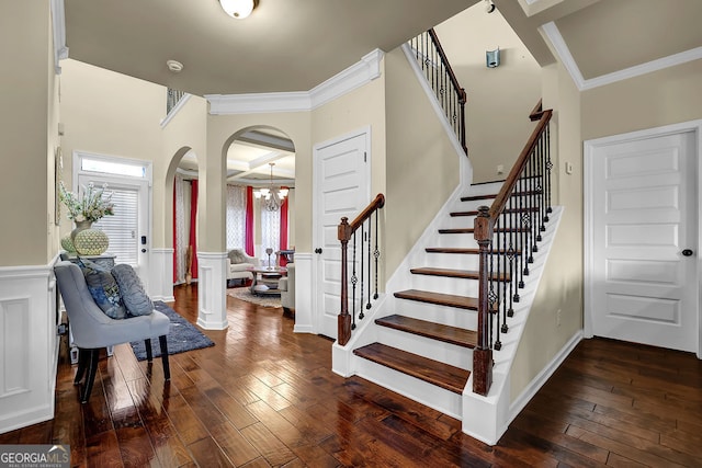 4581 Sagebrush Ct, Snellville, GA 30039 - foyer featuring crown molding, arched walkways, hardwood / wood-style flooring, wainscoting, and stairway