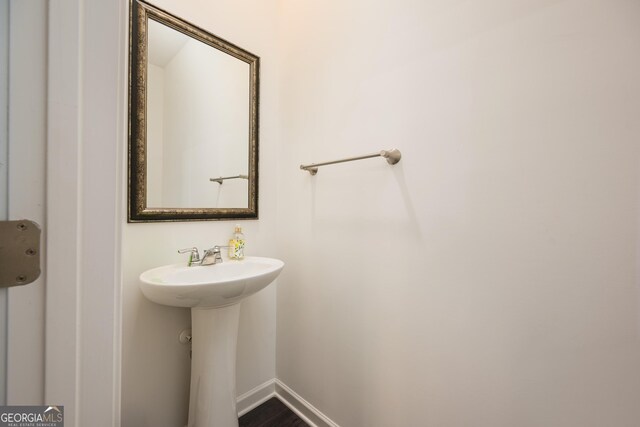 668 Isom Walk, Suwanee, GA 30024 - bathroom featuring baseboards, a sink, and wood finished floors