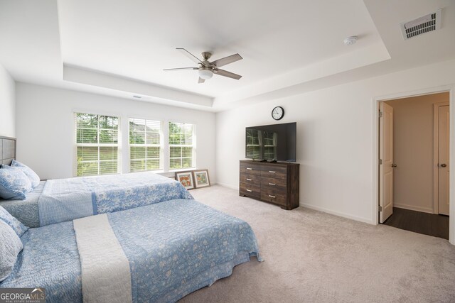 668 Isom Walk, Suwanee, GA 30024 - bedroom featuring a tray ceiling, carpet floors, ceiling fan, and baseboards