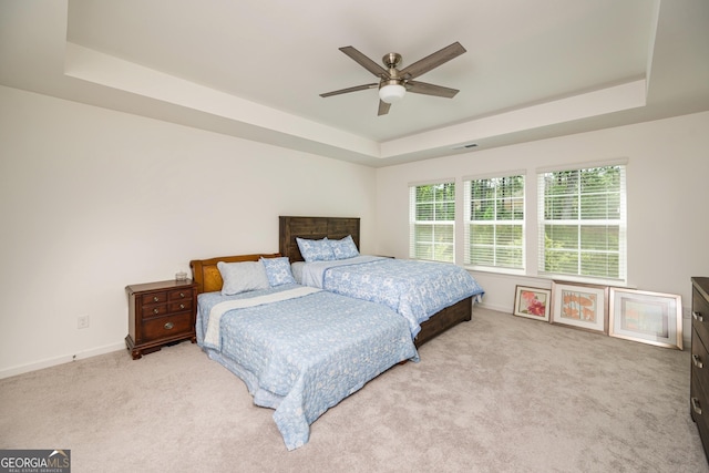 668 Isom Walk, Suwanee, GA 30024 - carpeted bedroom featuring a raised ceiling, baseboards, and ceiling fan