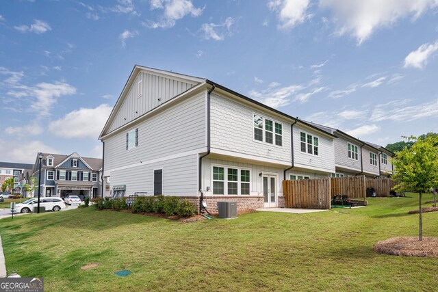 668 Isom Walk, Suwanee, GA 30024 - rear view of house with board and batten siding, french doors, central AC, and brick siding