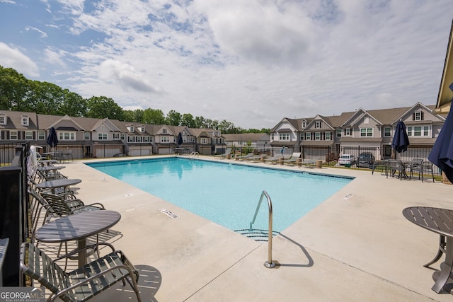 668 Isom Walk, Suwanee, GA 30024 - community pool with fence, a residential view, and a patio area
