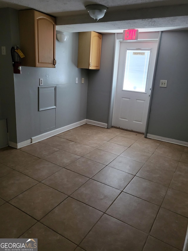 957 Astor Ave, Forest Park, GA 30297 - kitchen featuring light tile patterned flooring and baseboards