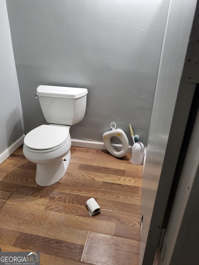 957 Astor Ave, Forest Park, GA 30297 - bathroom with wood finished floors, baseboards, and toilet