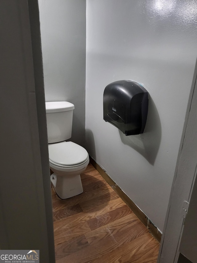 957 Astor Ave, Forest Park, GA 30297 - bathroom with toilet, wood finished floors, and baseboards