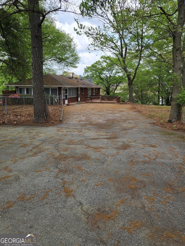 957 Astor Ave, Forest Park, GA 30297 - view of yard featuring driveway, a wooden deck, and fence