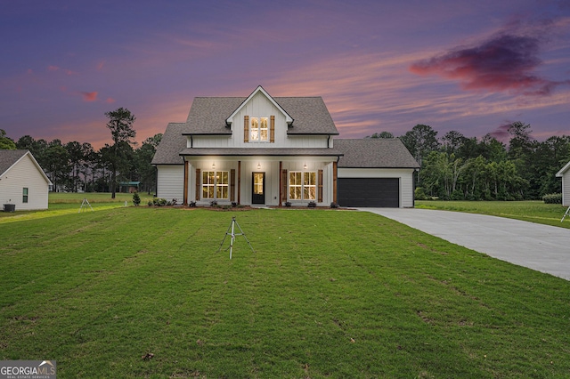 1573 Cabin Creek Trl, Griffin, GA 30223 - modern farmhouse style home featuring driveway, a front lawn, an attached garage, covered porch, and board and batten siding