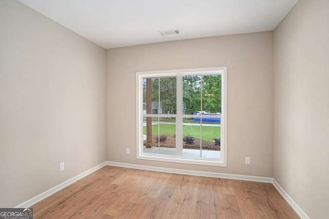 1573 Cabin Creek Trl, Griffin, GA 30223 - empty room featuring plenty of natural light, baseboards, and light wood finished floors