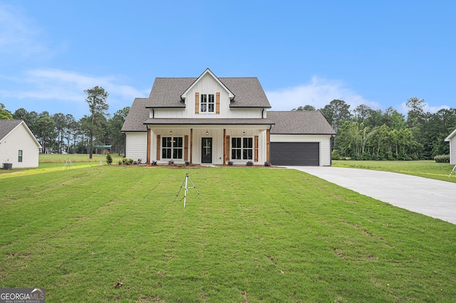 1573 Cabin Creek Trl, Griffin, GA 30223 - modern farmhouse style home with driveway, a porch, a front yard, an attached garage, and board and batten siding