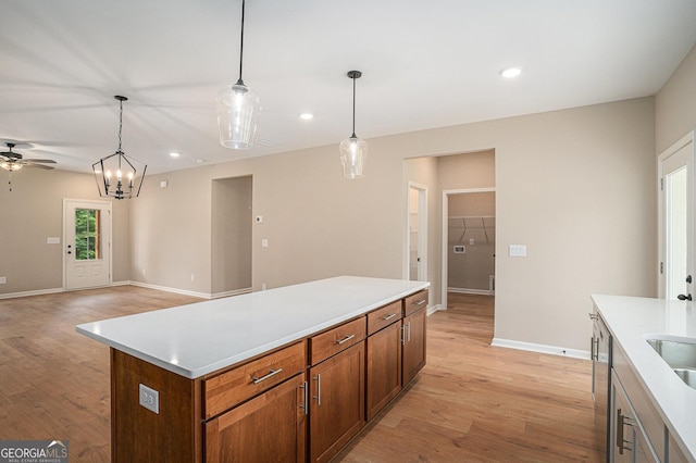 1573 Cabin Creek Trl, Griffin, GA 30223 - kitchen featuring baseboards, light wood-type flooring, a ceiling fan, a kitchen island, and recessed lighting