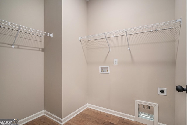 1573 Cabin Creek Trl, Griffin, GA 30223 - laundry room with hookup for a washing machine, electric dryer hookup, wood finished floors, and baseboards