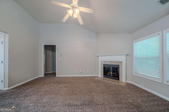 unfurnished living room featuring vaulted ceiling, carpet floors, a high end fireplace, and baseboards