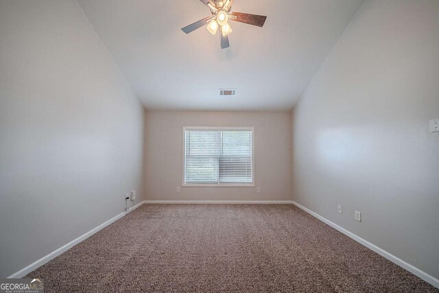 carpeted empty room featuring a ceiling fan and baseboards