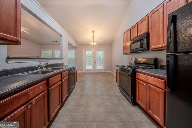 kitchen featuring black appliances, a sink, dark countertops, french doors, and vaulted ceiling
