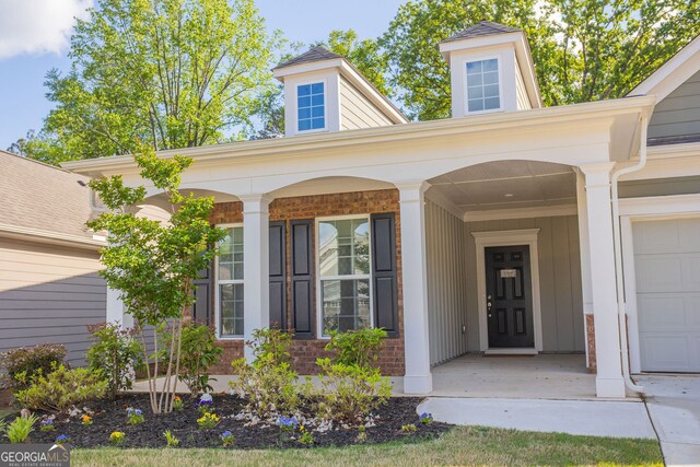 view of exterior entry featuring a porch