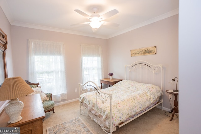 bedroom with light colored carpet, crown molding, baseboards, and a ceiling fan