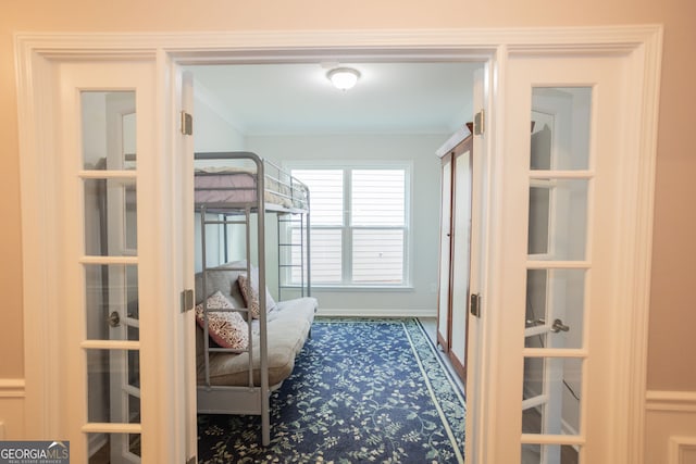 bedroom with ornamental molding and baseboards