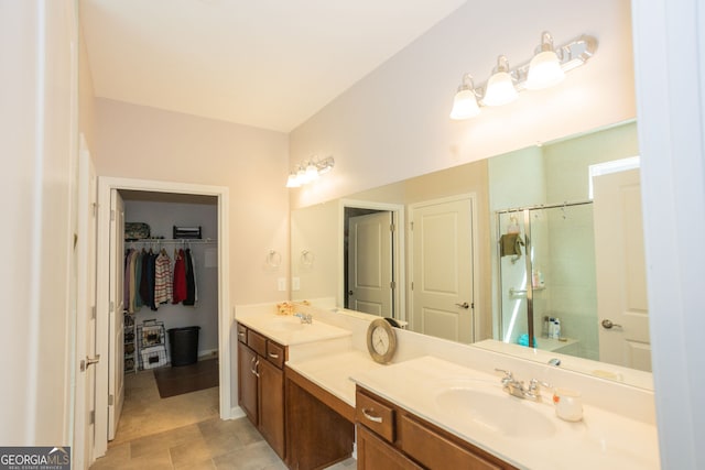 full bath with a shower, double vanity, and a spacious closet